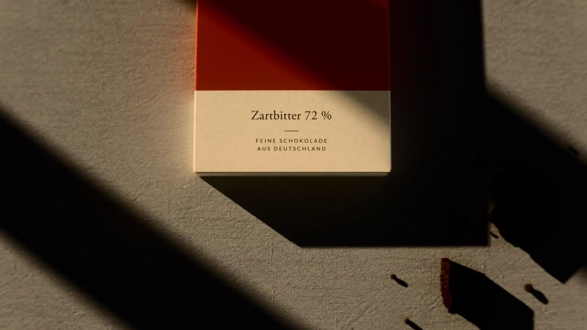 FALZ dark chocolate from above, light stripe on the label, chocolate pieces in shadow